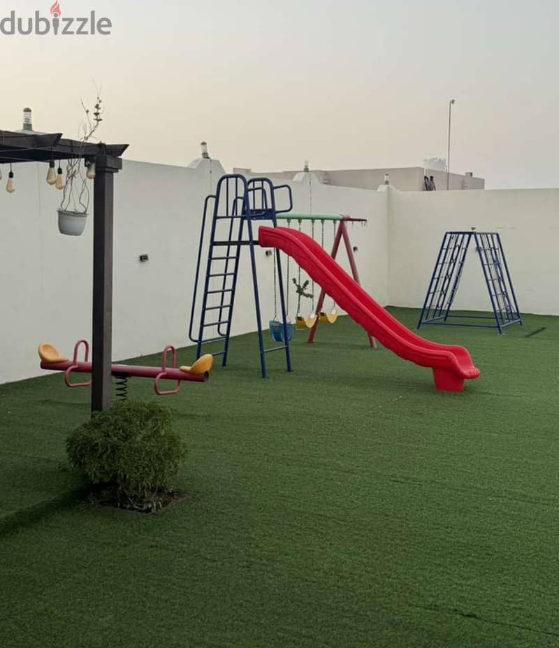 Children's slide, swings and seesaw