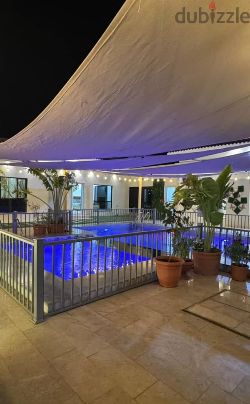 Covered pool terrace at night